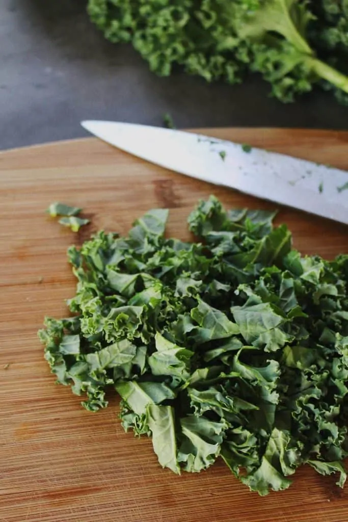 a knife and chopped kale for autumn kale salad