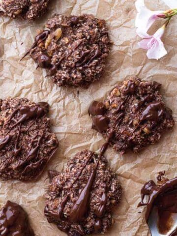 keto no bake chocolate cookies on parchment paper with flowers