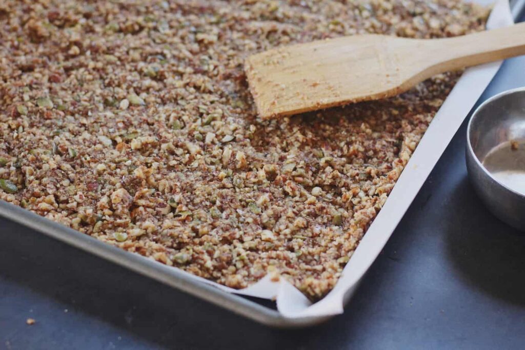 grain-free pumpkin granola pressed into baking sheet