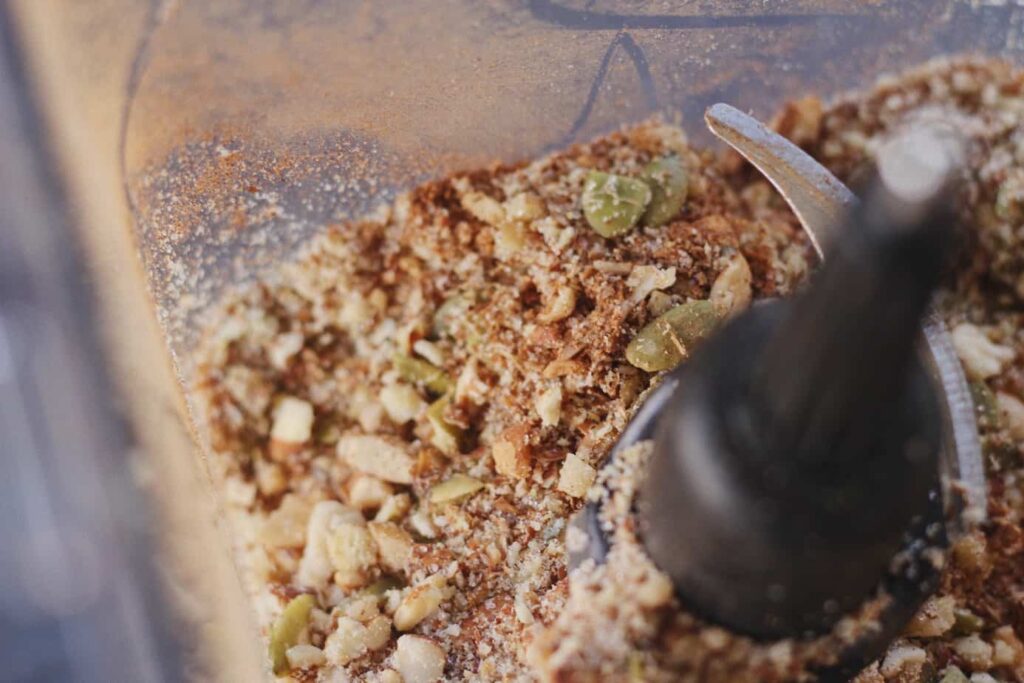 closeup of dry grain-free granola mixture in blender