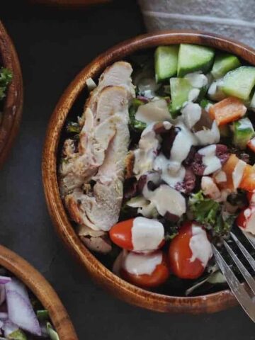 closeup of kale greek salad with garlic tahini dressing