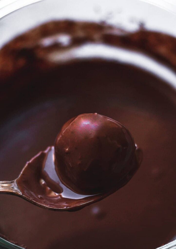 chocolate on a keto marzipan truffle in a spoon