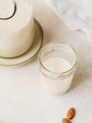 shot of homemade almond milk in a jar glass