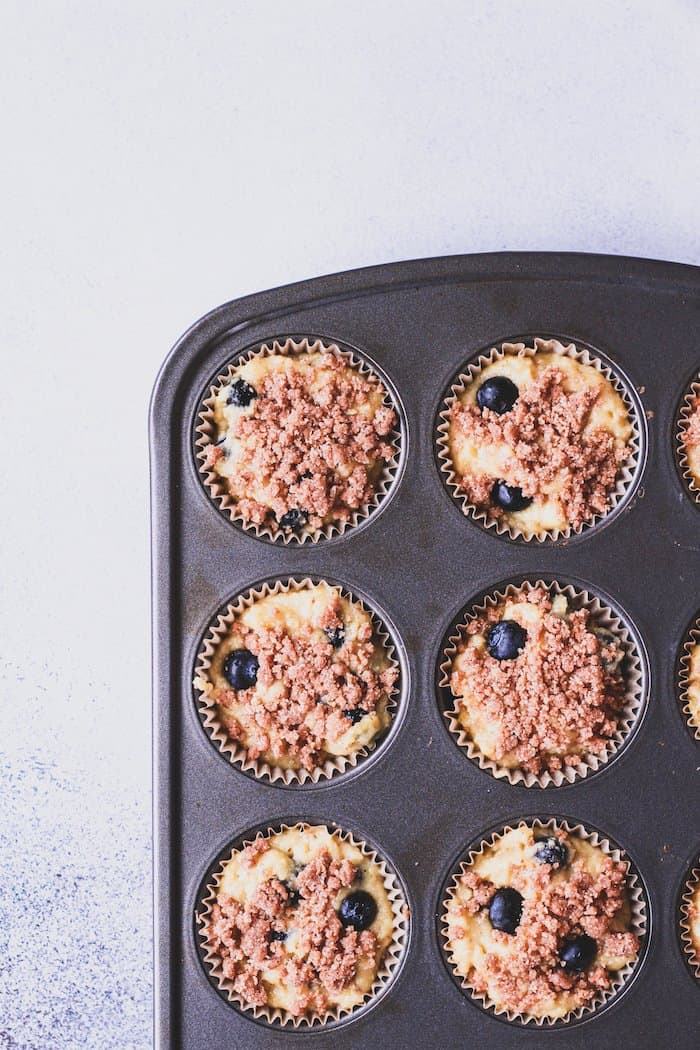Keto and almond flour blueberry muffins in muffin tin.