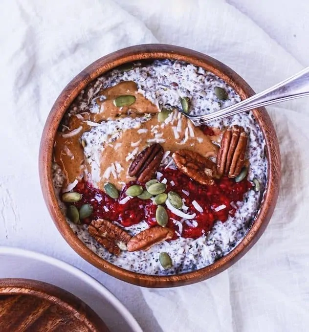 overhead of keto oatmeal with toppings in a wooden bowl