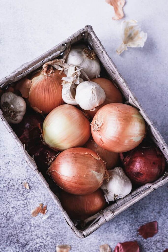 onions and garlic in a basket