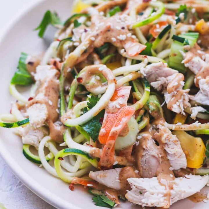 zucchini noodle salad with spicy peanut sauce on a plate