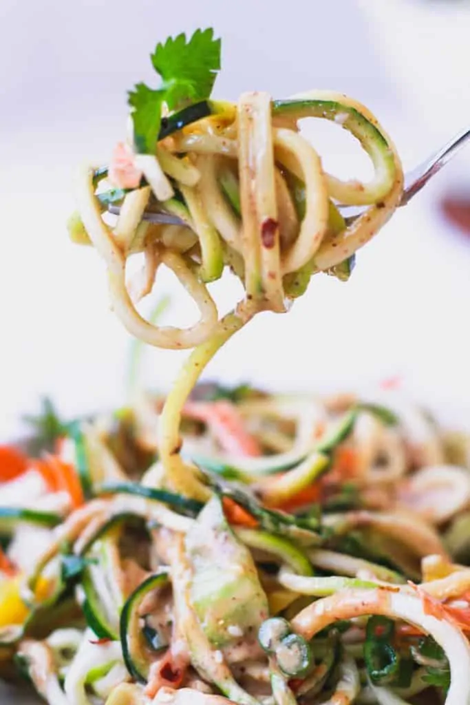 bite of zucchini noodle salad with spicy peanut sauce