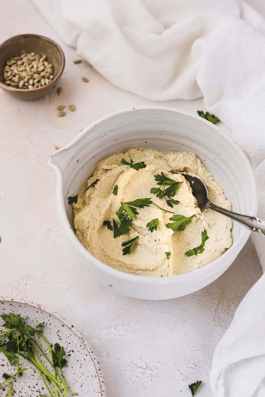 sunflower cashew ricotta in a bowl with parsley