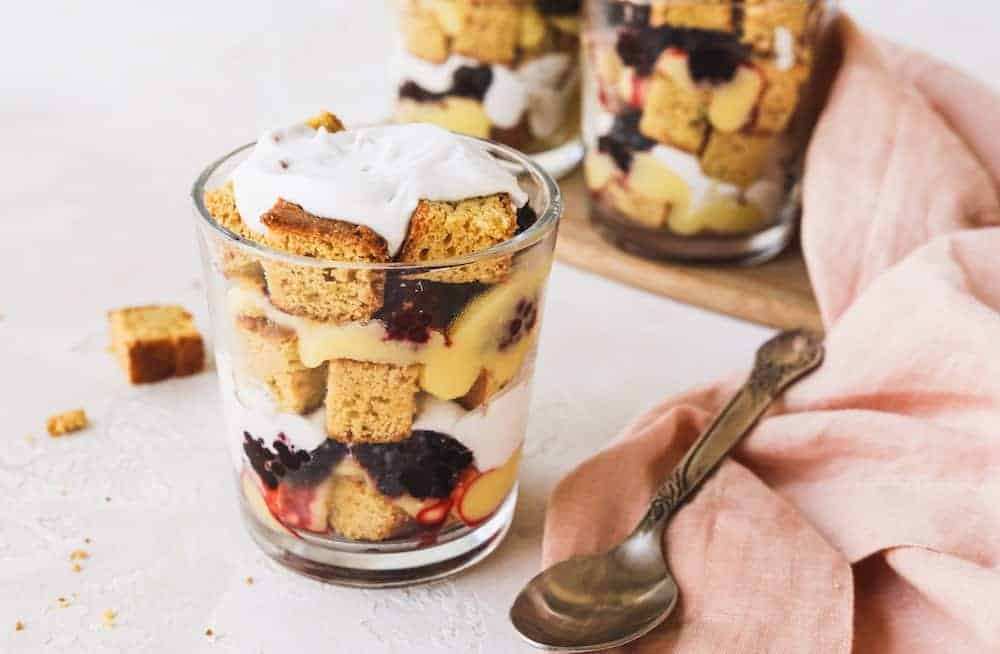 three keto cake trifle cups with a pink napkin