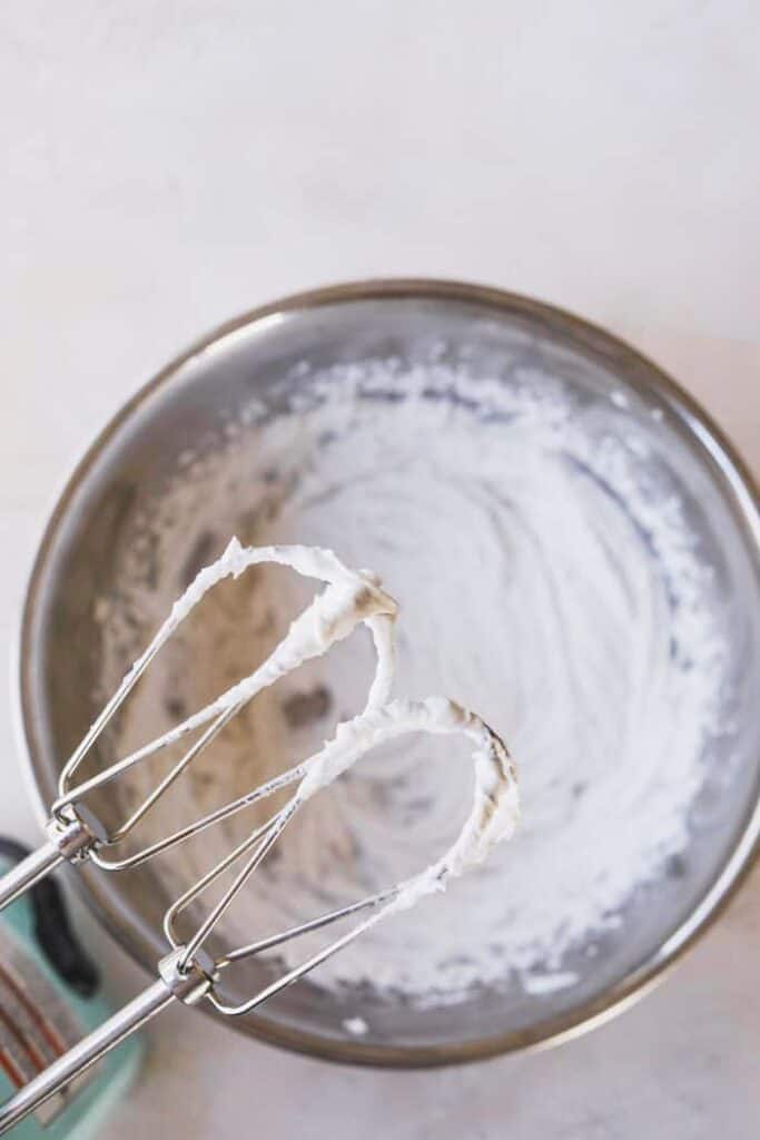 closeup of mixer tines with coconut whipped cream