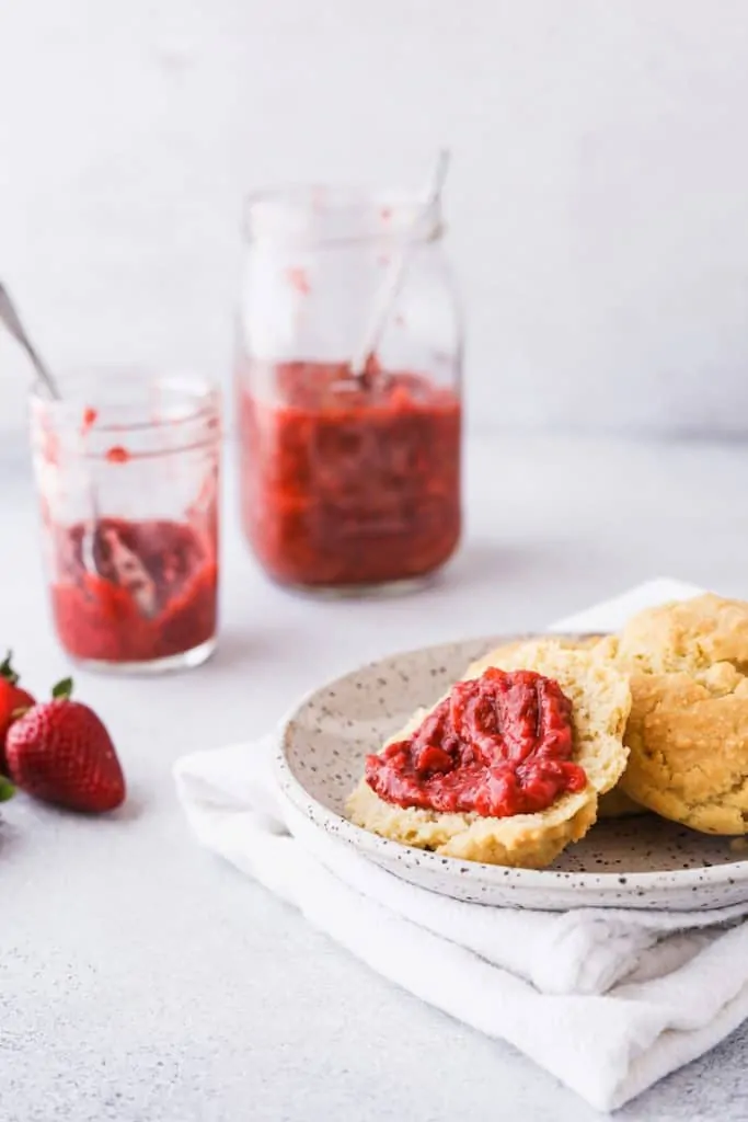 low-carb strawberry rhubarb chia jam on biscuit on a plate