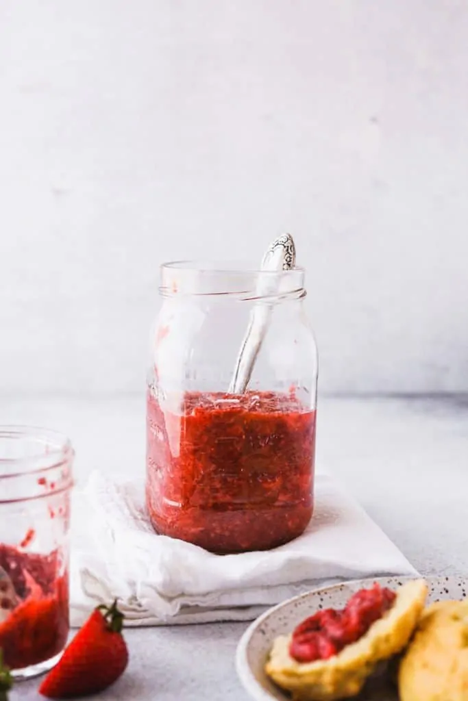 low-carb strawberry rhubarb chia jam in a jar with a spoon