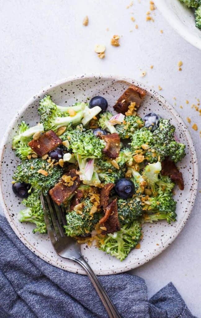 keto broccoli salad with bacon on a plate with a fork