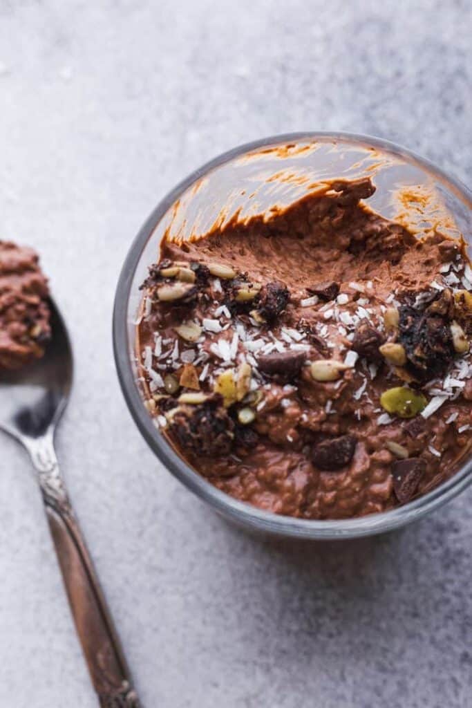 keto chocolate chia mousse in a glass with a spoon