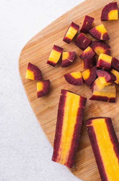closeup of purple carrot on chopping board