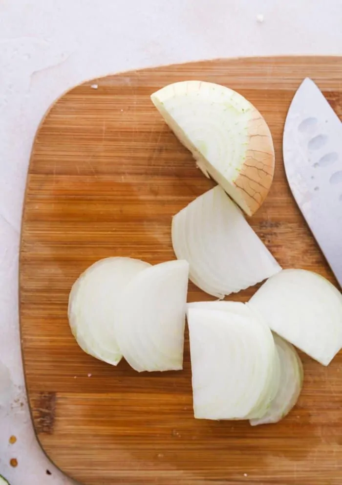 onion on chopping board with a knife