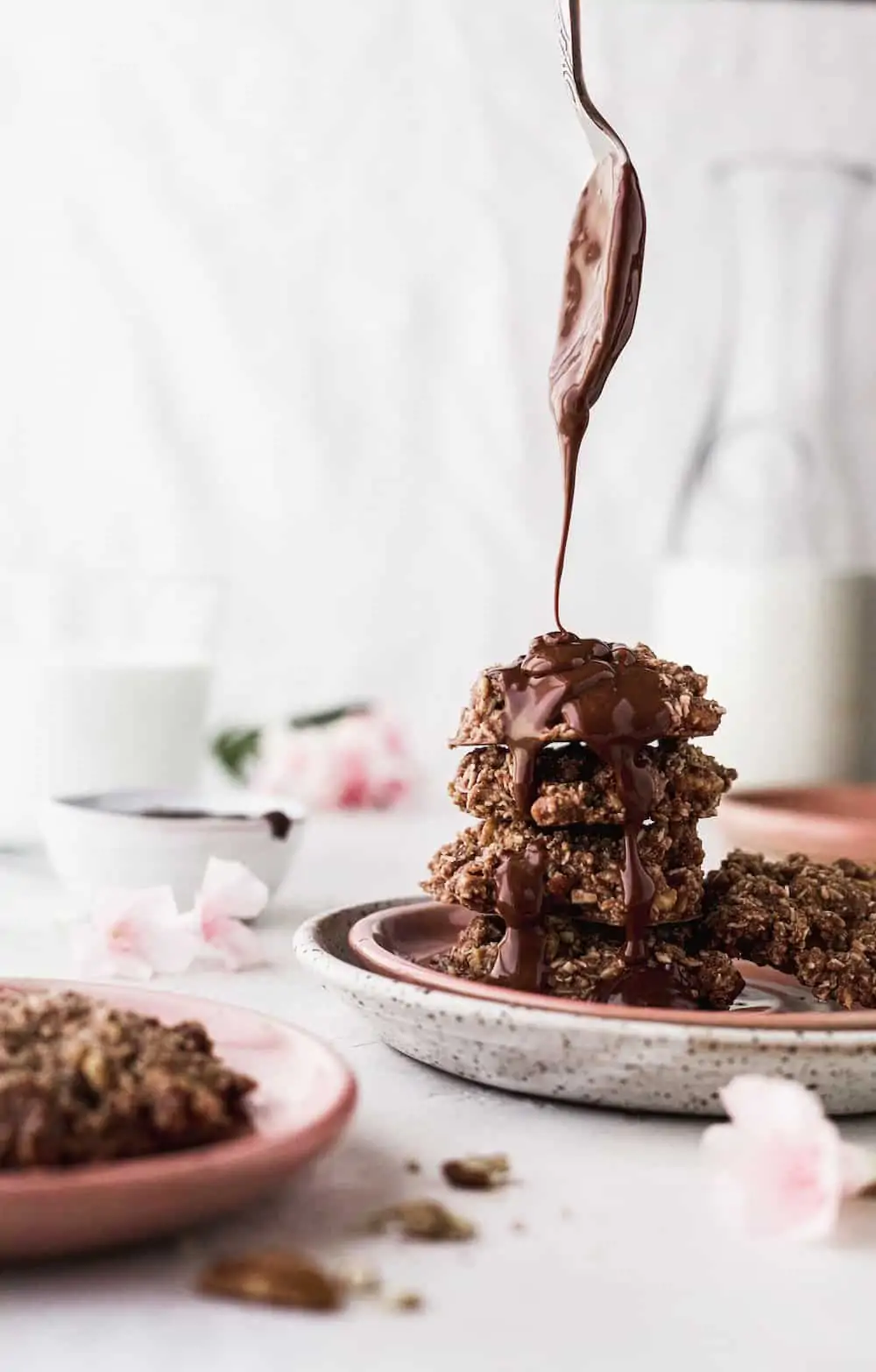 a spoon drizzle chocolate on keto no bake chocolate cookies