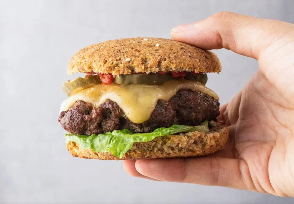 closeup of holding a low-carb burger