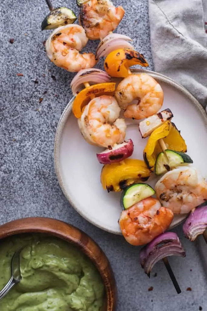 grilled shrimp skewers on a plate with a napkin