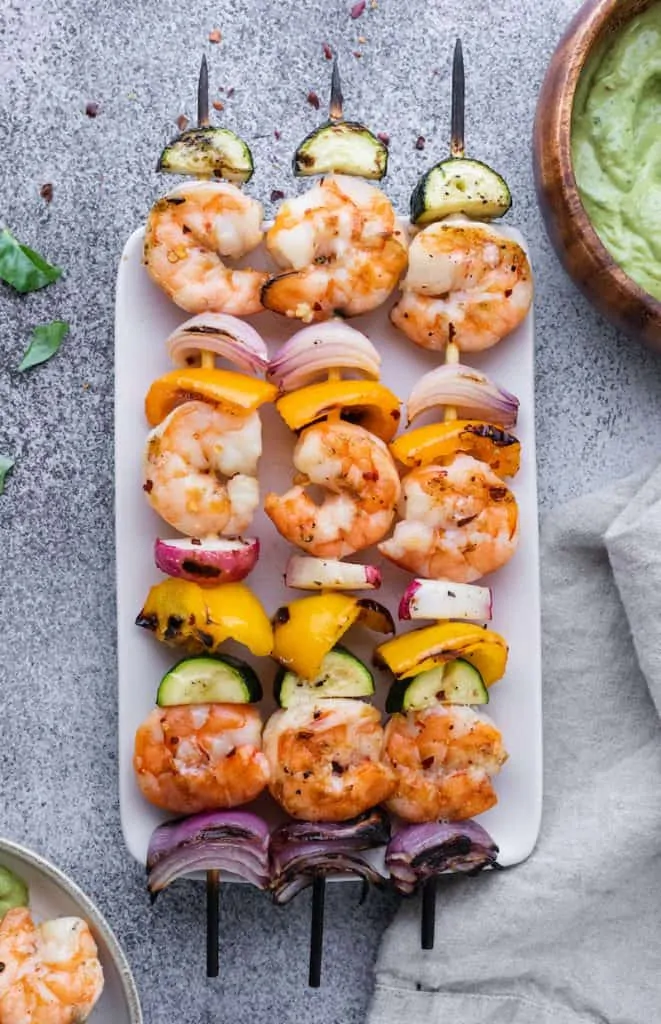 grilled shrimp skewers on a rectangular plate