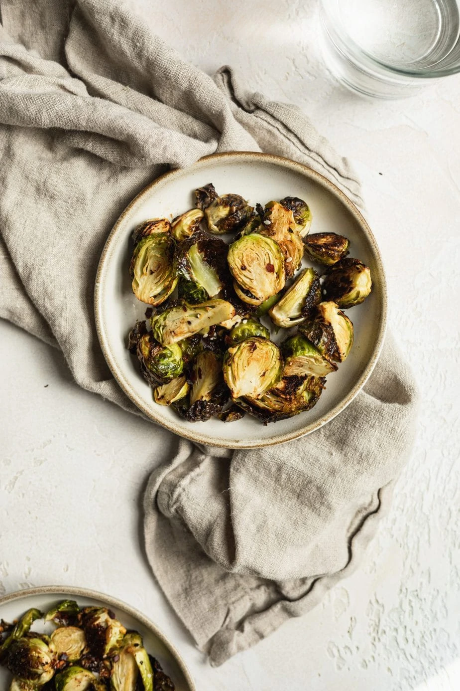 plate of air fryer brussels sprouts keto with a beige linen napkin