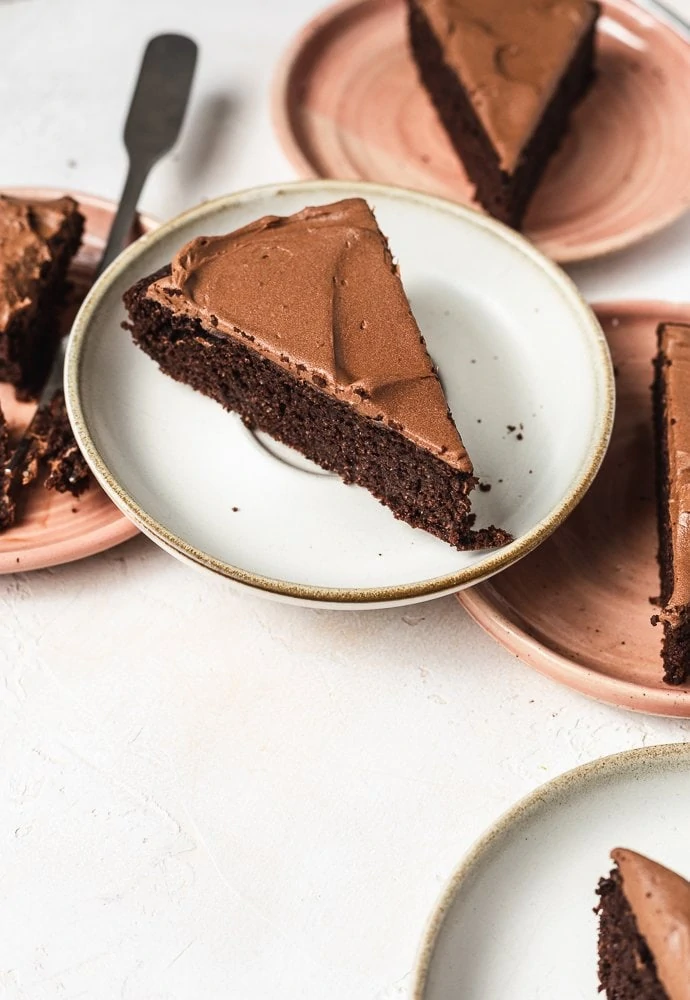 A slice of keto chocolate cake on a white plate. 