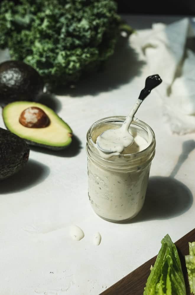 A jar of keto ranch dressing with a spoon.