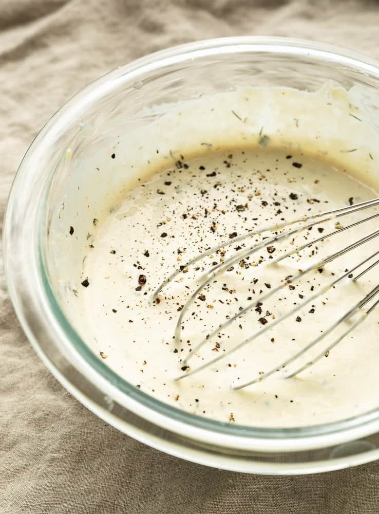keto ranch dressing in a bowl with a whisk