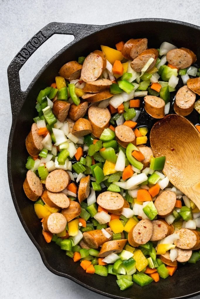 veggies and sausage in a cast iron skillet