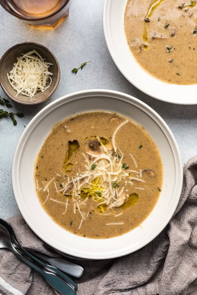 Healthy mushroom soup in a bowl with garnishes.