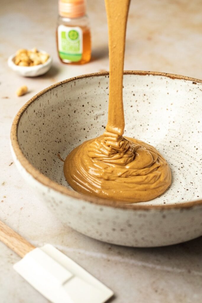 pouring peanut butter into a bowl