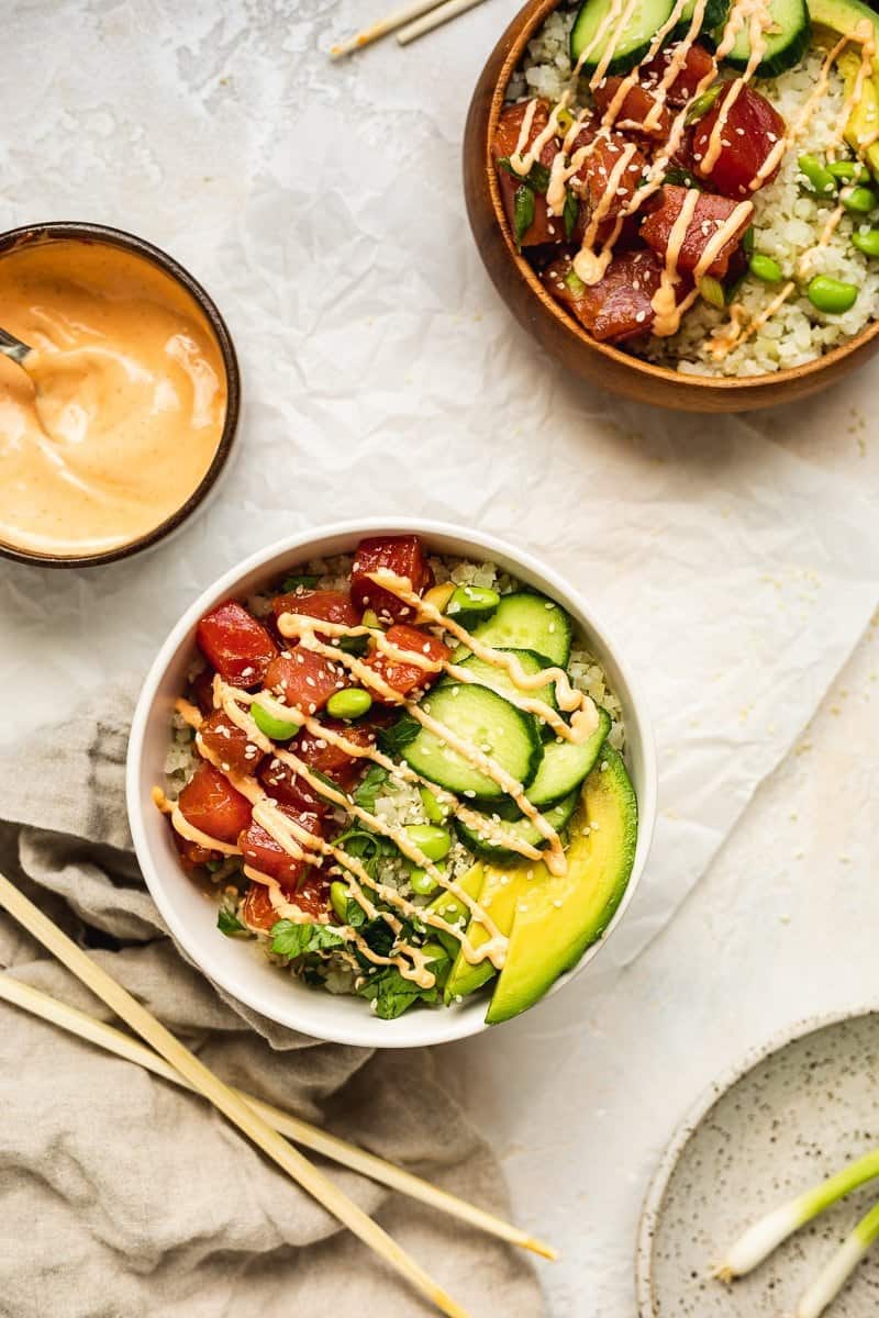 two keto poke bowls with chopsticks and spicy mayo