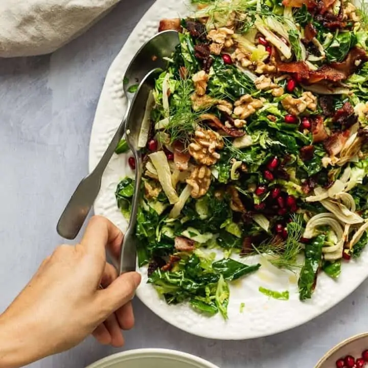 hand serving Brussels sprouts and kale salad