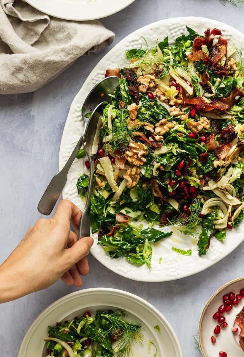 hand serving Brussels sprouts and kale salad