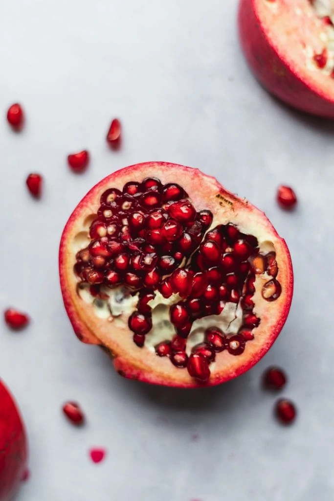 closeup of open pomegranate and arils