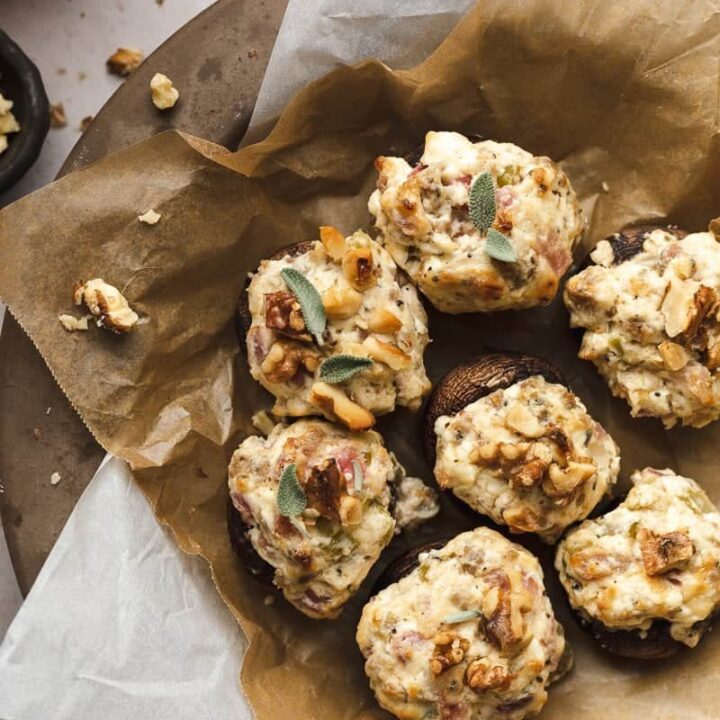 keto stuffed mushrooms on a plate with parchment paper