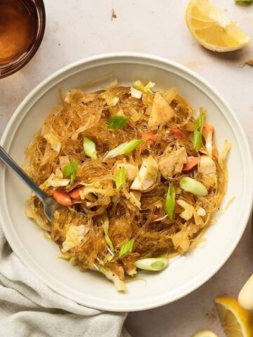 pancit with kelp noodles in a bowl with a glass and knife for Filipino pancit recipe