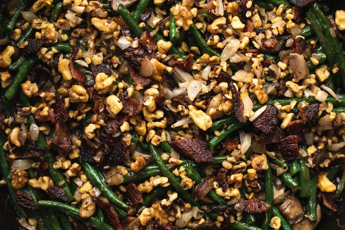 Closeup of the bacon, walnut and shallot topping on top of the keto green bean casserole