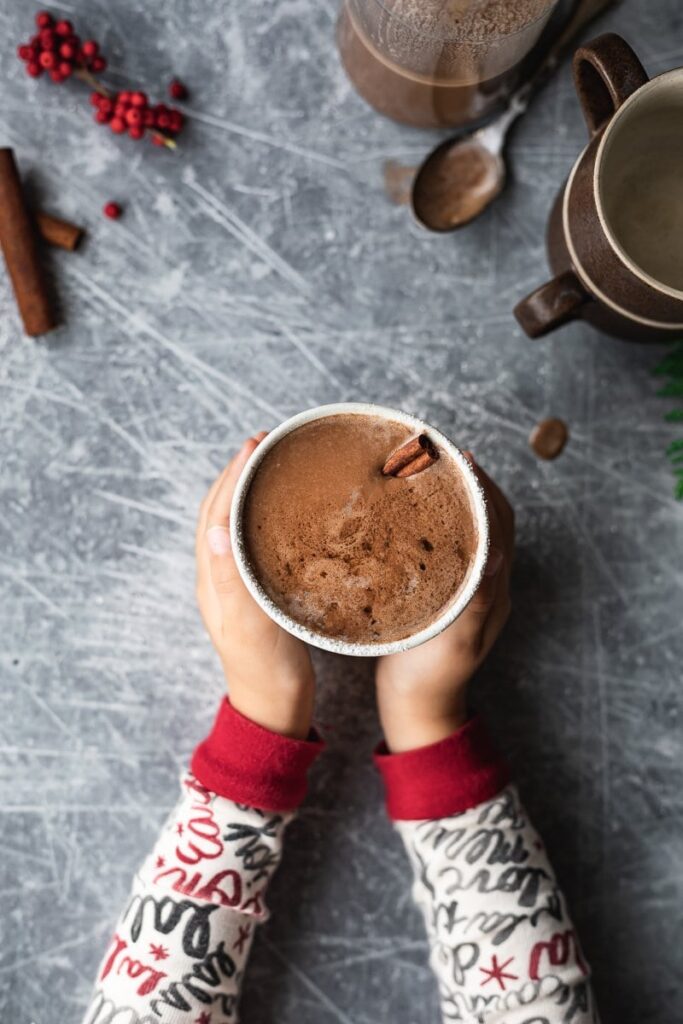 little hands holding mug of keto hot cocoa