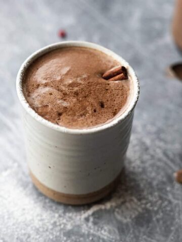 mug of keto hot cocoa with cinnamon stick
