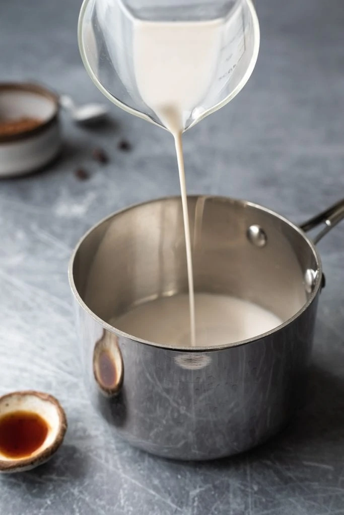 pouring dairy-free milk into pan