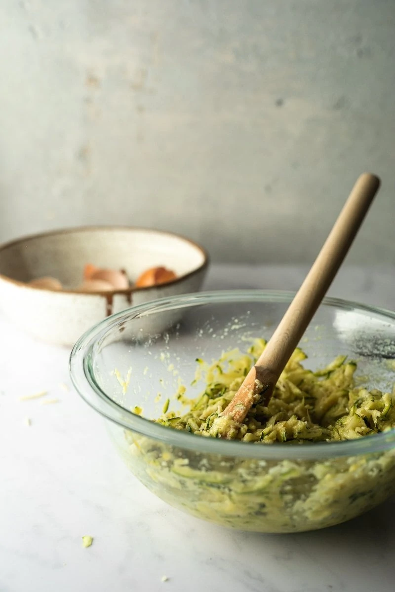 Keto zucchini fritter batter in a bowl.