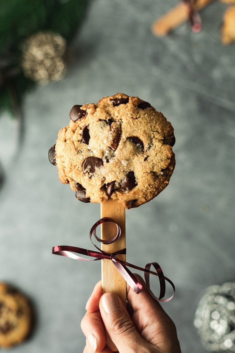 holding a salted caramel chip cookie pop