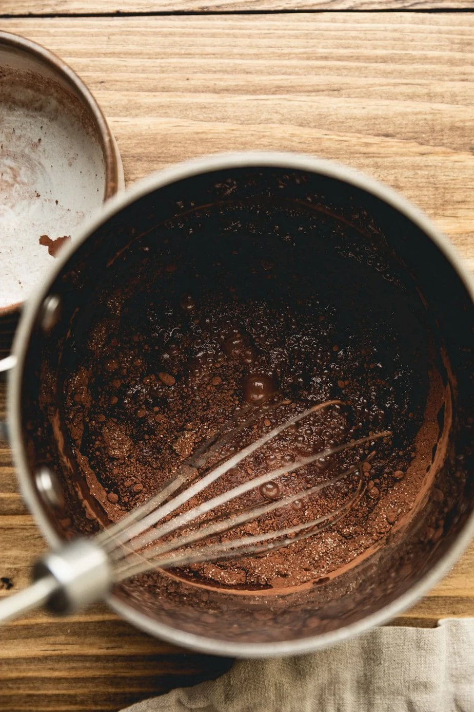 whisking chocolate sauce in a sauce pan