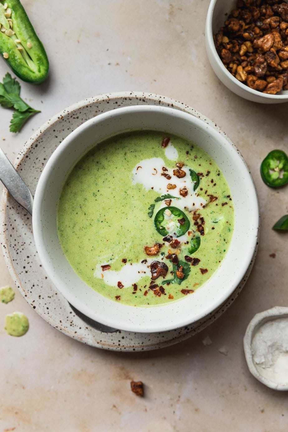 A serving with garnishes on top of the broccoli jalapeño soup. 