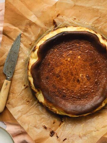 whole keto Basque burnt cheesecake on brown parchment paper