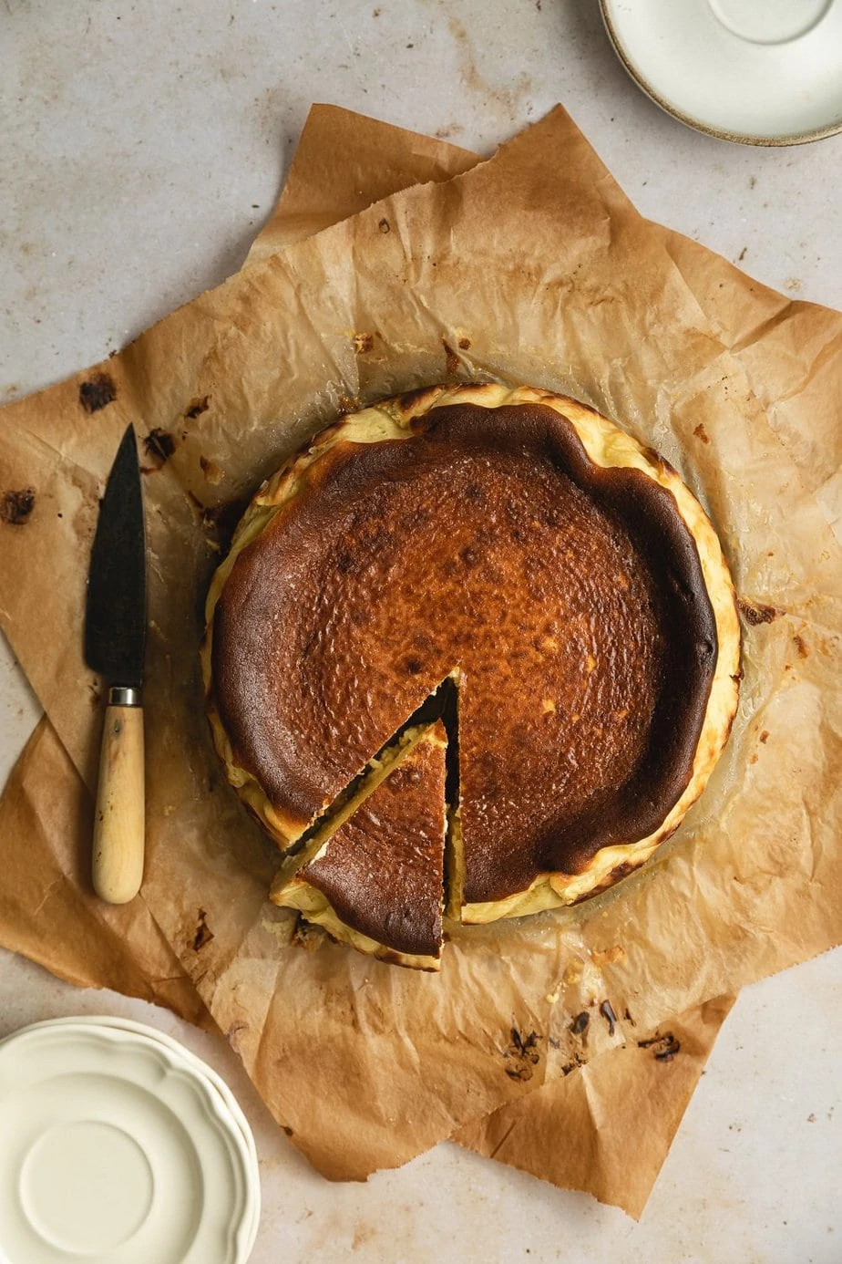 whole Basque burnt cheesecake with a slice cut out