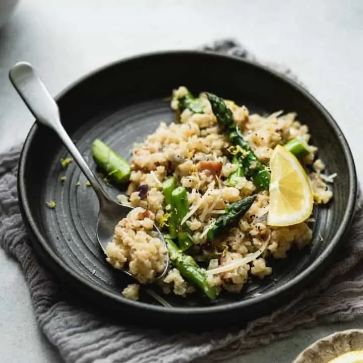 cauliflower risotto on a plate with a spoon HERO