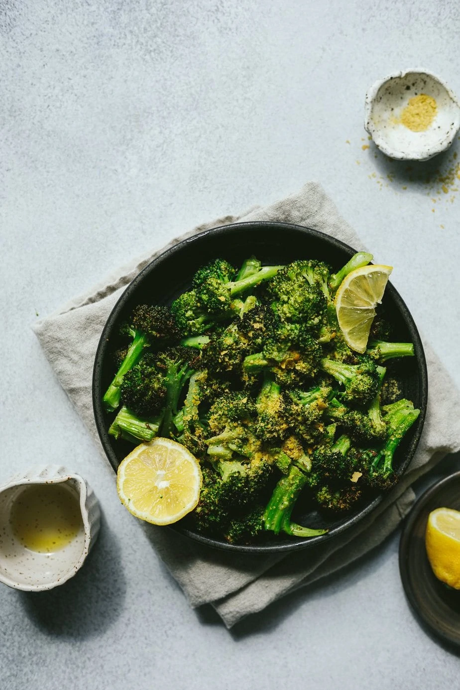 air fryer broccoli with nutritional yeast on a black plate